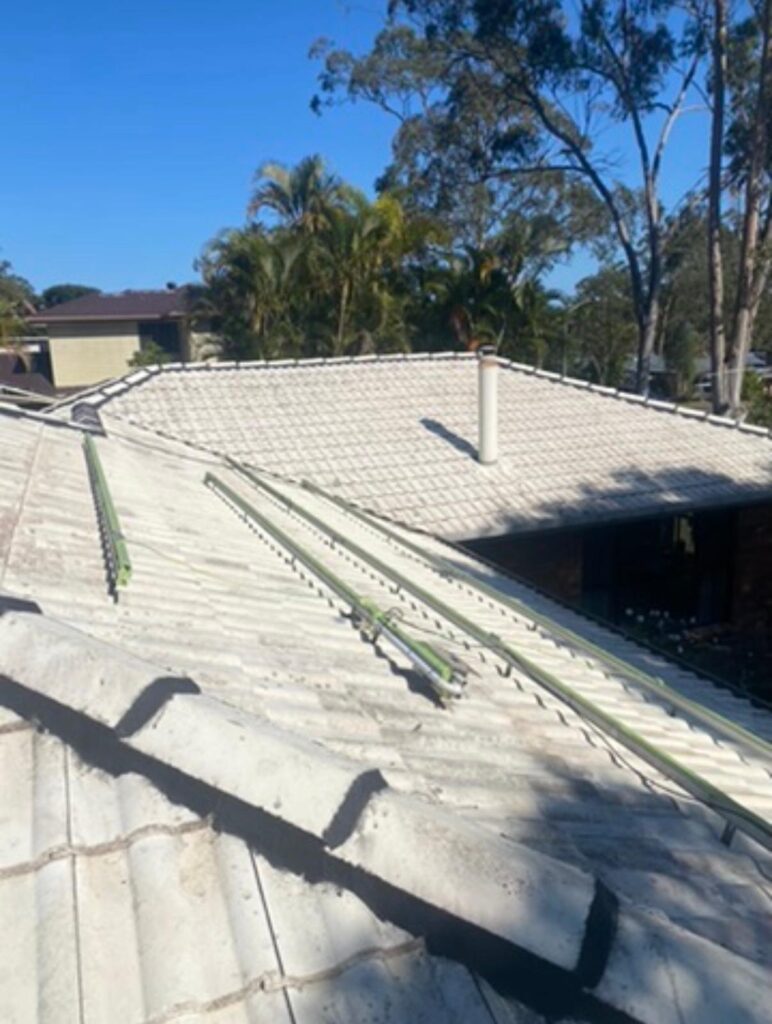 Faded concrete tile roof prior to professional roof painting and restoration