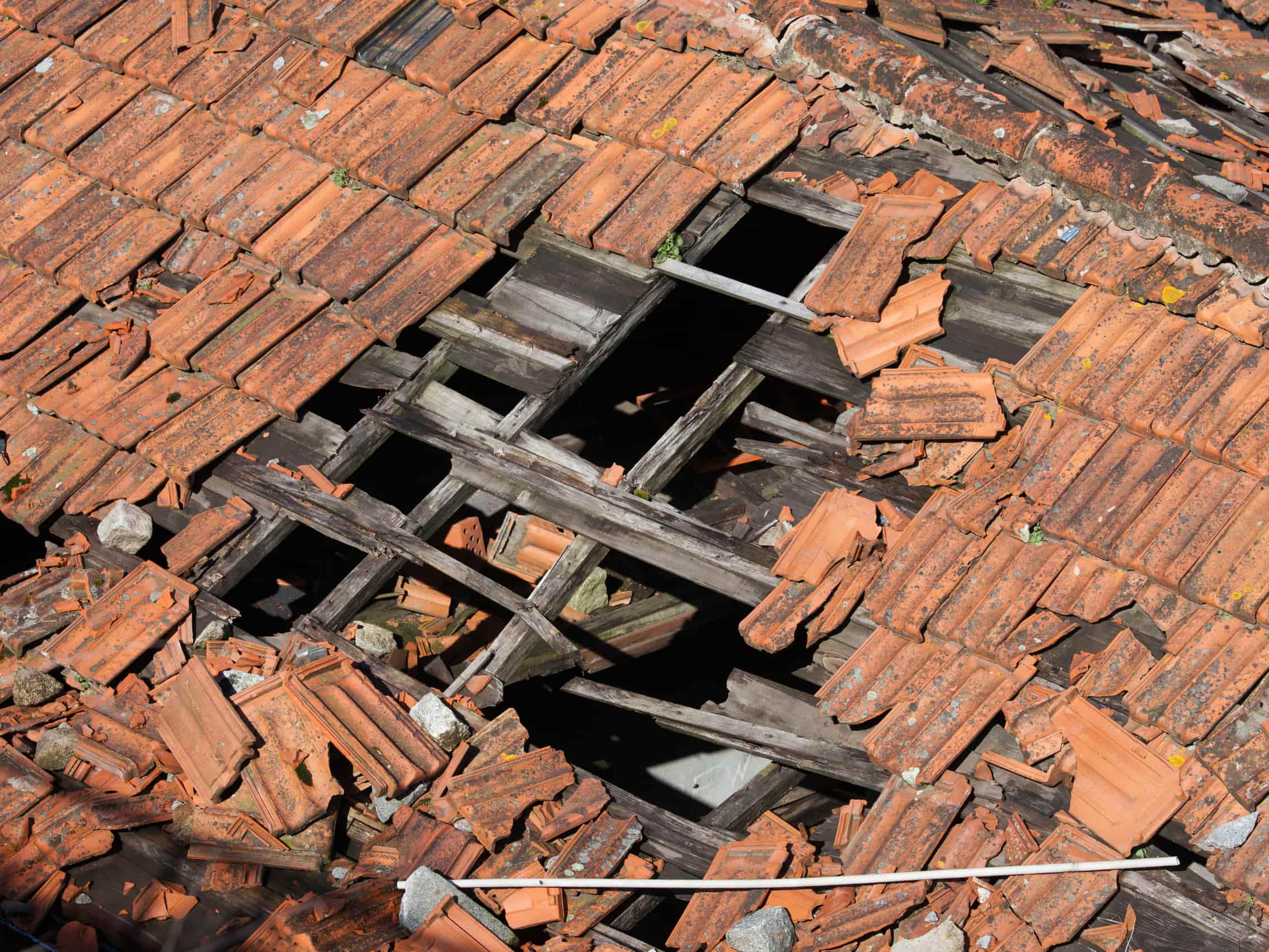 Collapsed roofs exposing wooden timber frames needing complete roof restoration